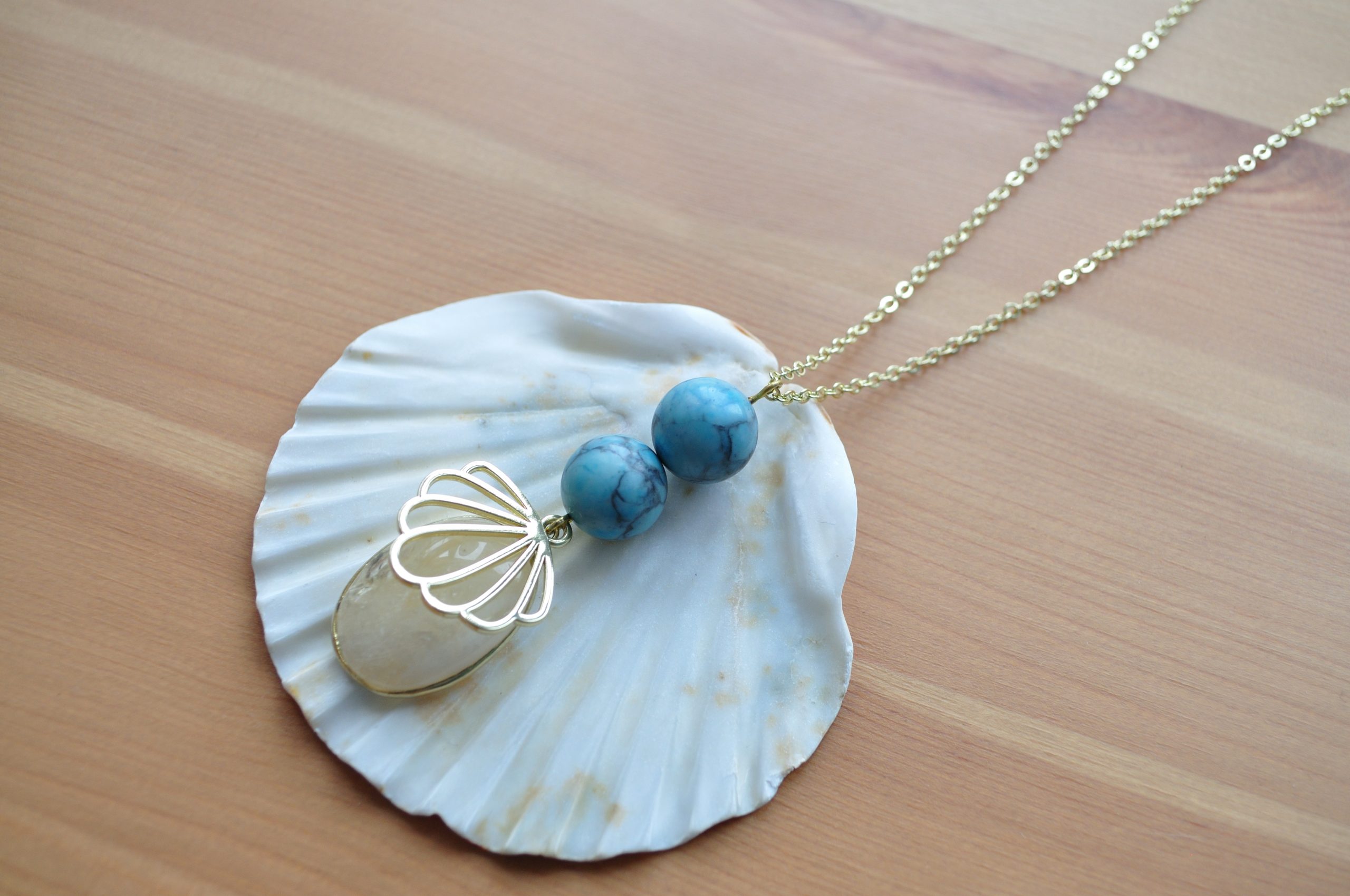 fine, gold-plated necklace with light blue Howlite, Quartz Cabochon and stylised shell pendant