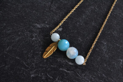 golden necklace light blue feather pendant